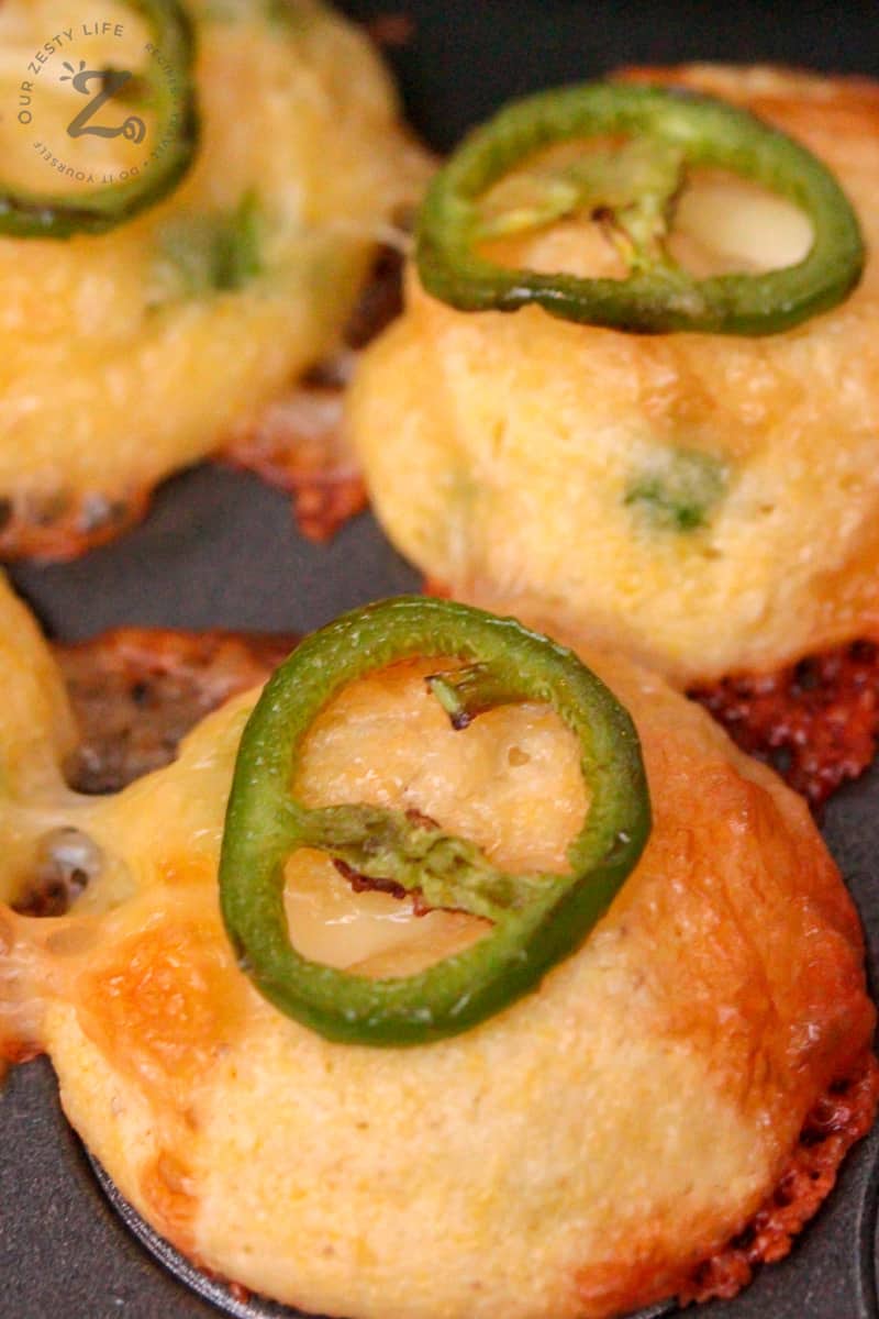Mini Jalapeno Popper Corn Muffins with a cream cheese center and sliced jalapenos on top