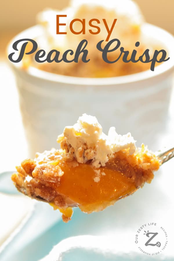 Easy Peach Crisp Recipe with peach crisp and ice cream on a spoon with an individual easy peach crisp in the background along with a light blue napkin