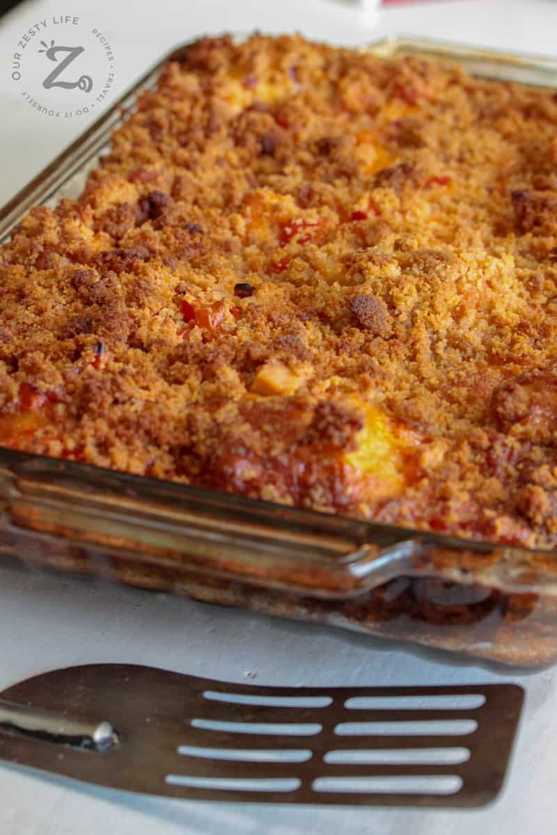 cooked breakfast bake casserole in the baking pan with a spatula on the side