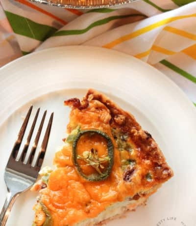 Jalapeno Popper Quiche on a white plate with a fork