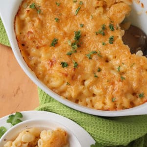 overhead of Homemade Baked Macaroni and Cheese in a casserole with a bowl of macaroni and cheese