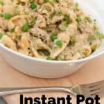Instant Pot Italian Chicken in a white bowl with a fork on the side