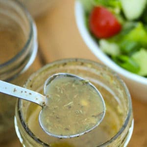 Italian Dressing (from mix) in a heart spoon with salad in the background