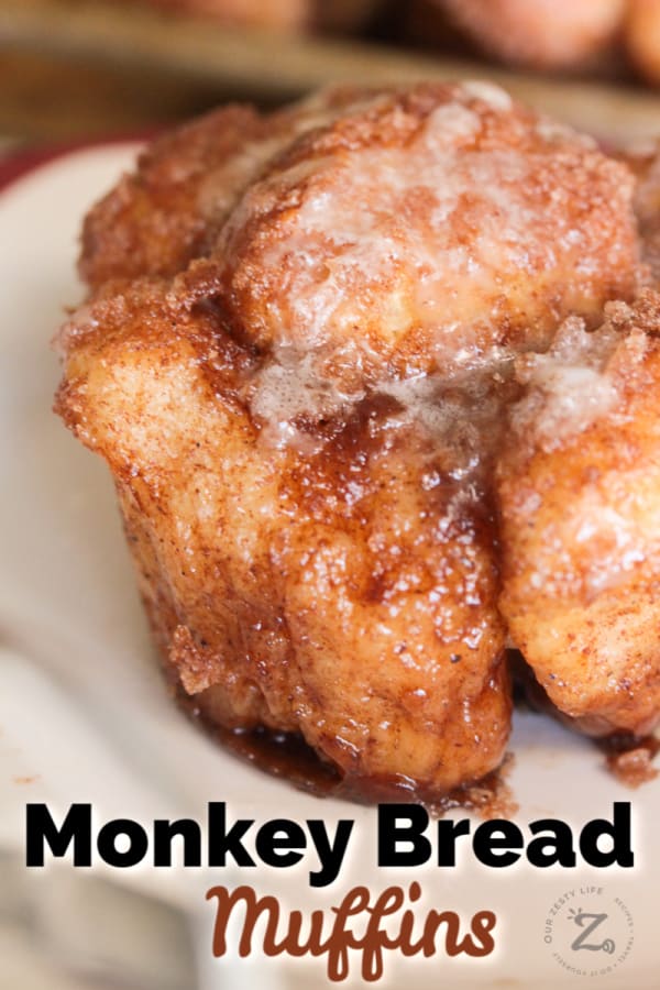 cinnamon monkey bread muffins with vanilla glaze on a white plate