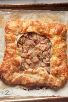baked square rhubarb galette on a cookie sheet with parchment paper