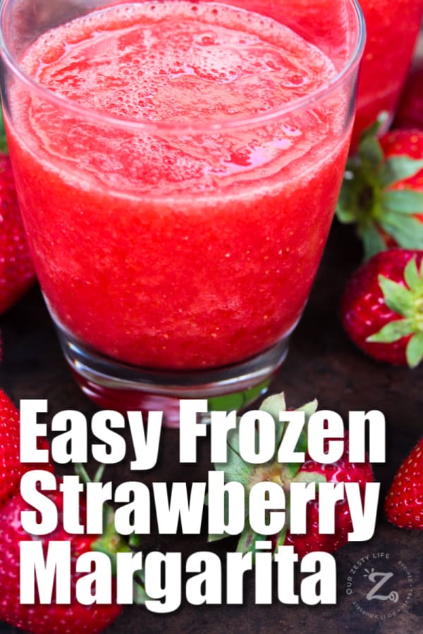 a glass with easy frozen strawberry margarita with strawberries in the foreground