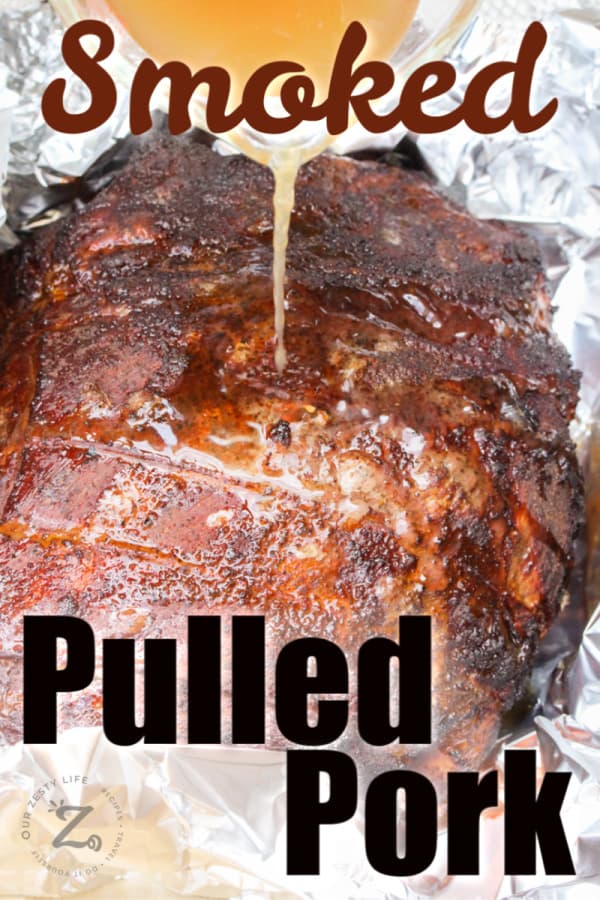 Pouring beef stock over pulled pork cooked roast before it is resealed in aluminum foil and placed back in the smoker