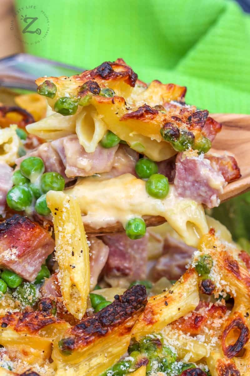 ham and pea pasta bake scooped out of a casserole dish