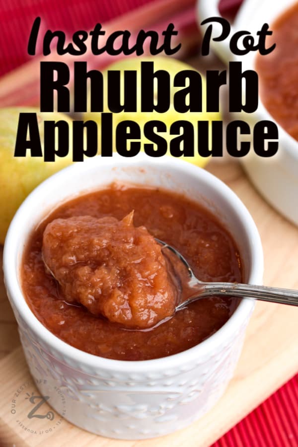 A close up of Instant Pot rhubarb applesauce in a white bowl and a spoonful of sauce removed