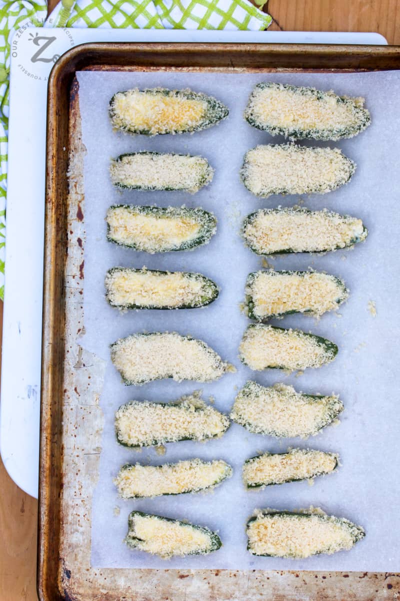 baking tray with parchment paper with homemade baked jalapeno poppers ready for the oven
