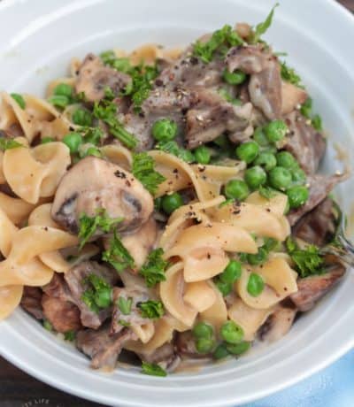 Easy Beef Stroganoff in a white bowl with a cloth on the side