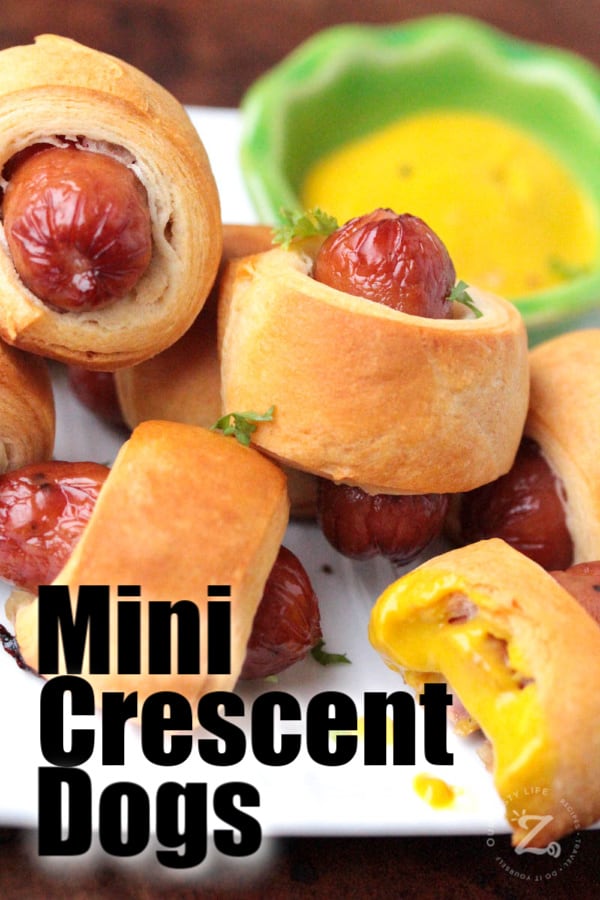 upper picture of 4 mini pigs in a blanket on a cookiClose up of 5 mini pigs in a blanket beside some mustard dipping sauce