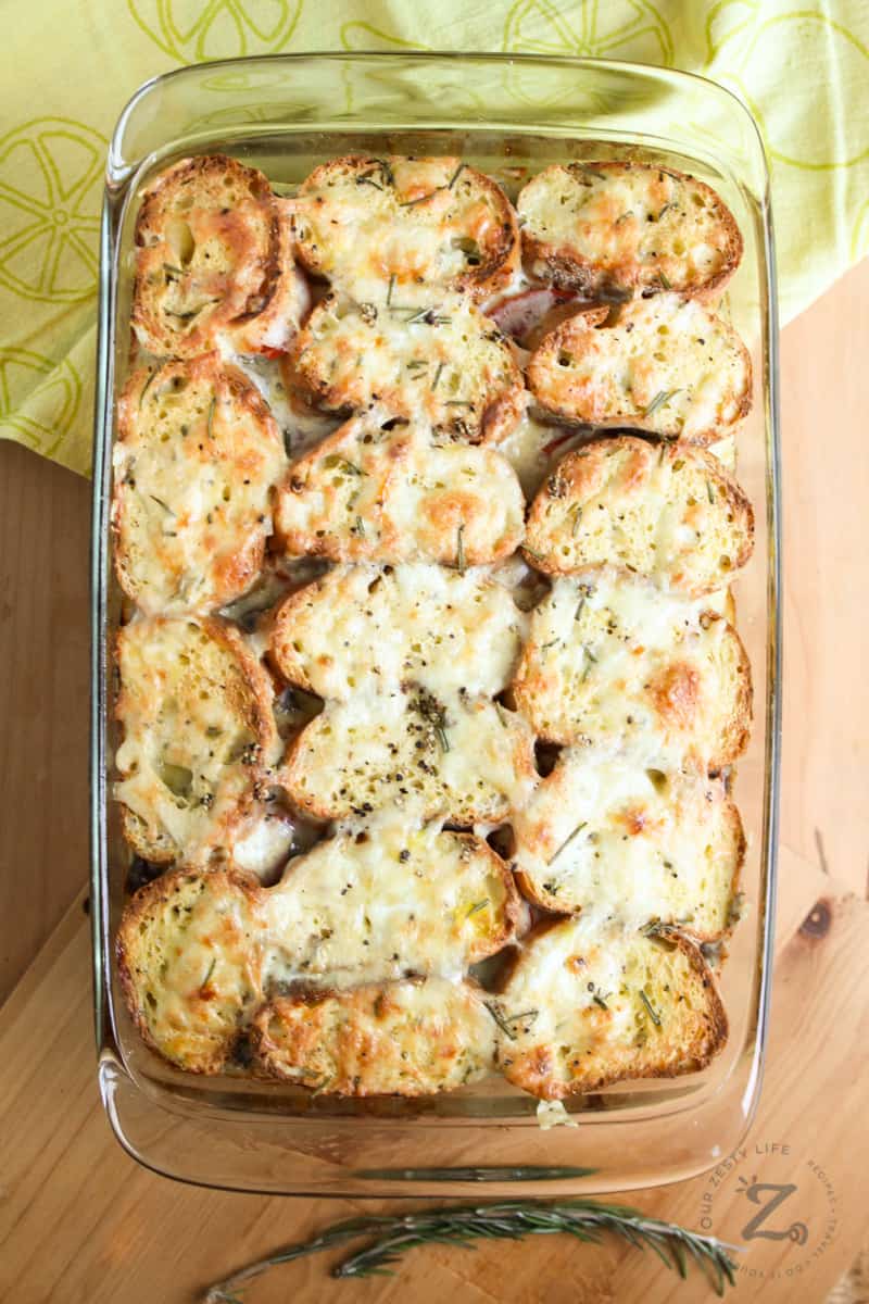 overhead view of breakfast strata with sausage baked in a glass dish with golden cheese on the top