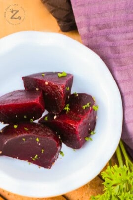 a close up of a plate of red beets cut into 5 pieces