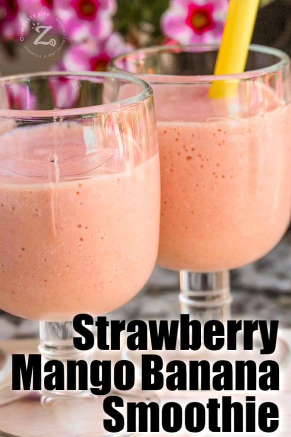 A close up of two glasses of strawberry mango smoothies on a tray