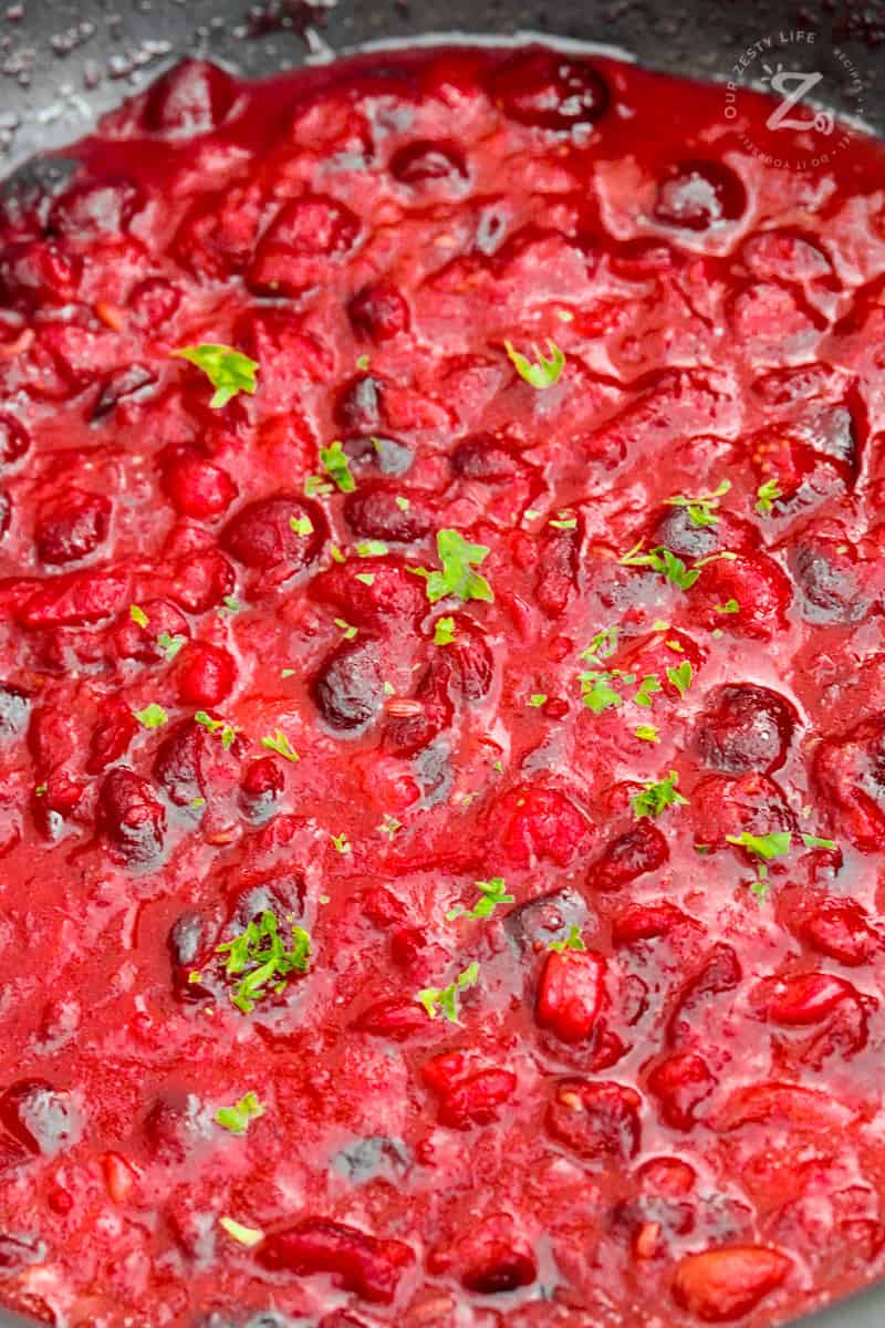 a close up of cranberry sauce simmering in a pot