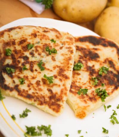 Irish potato pancakes on a white plate with parsley