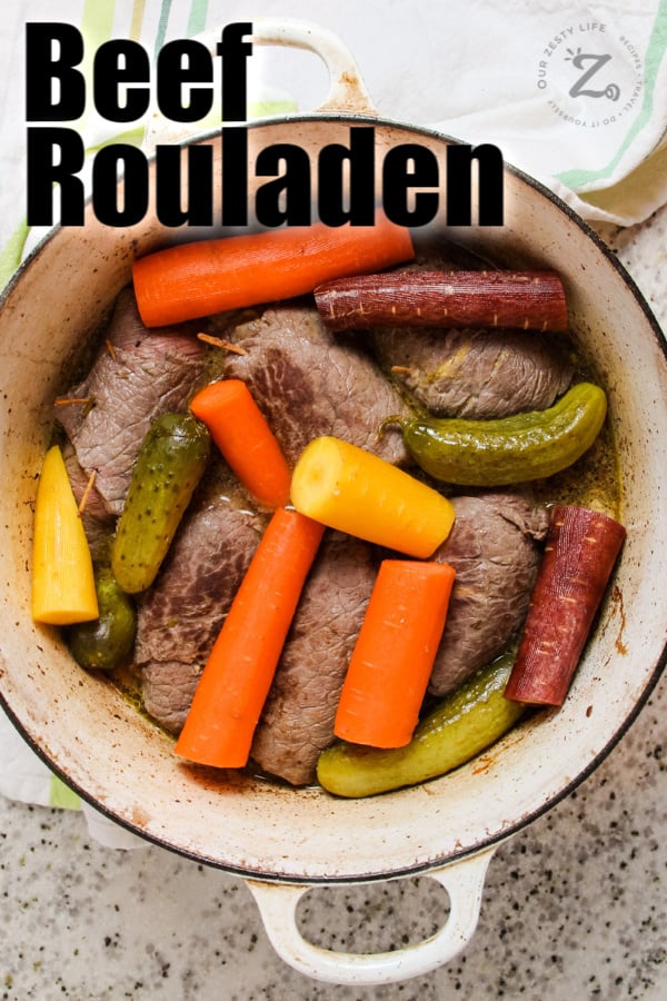 Beef Rouladen meat, carrots and pickles in a pot with writing