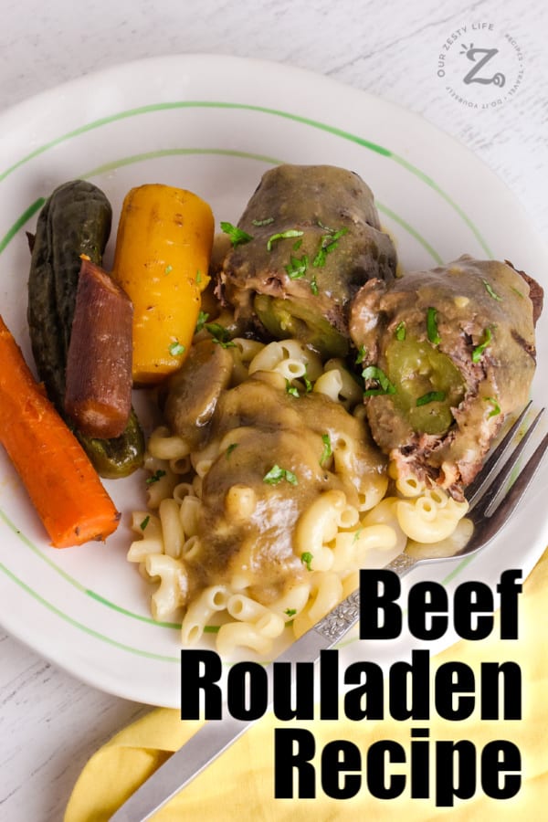 Beef rouladen served with carrots and macaroni with writing