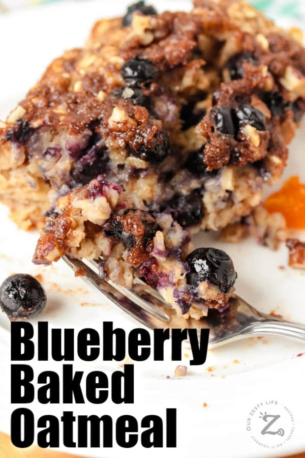 Blueberry banana baked oatmeal on a white plate with a bite on a fork