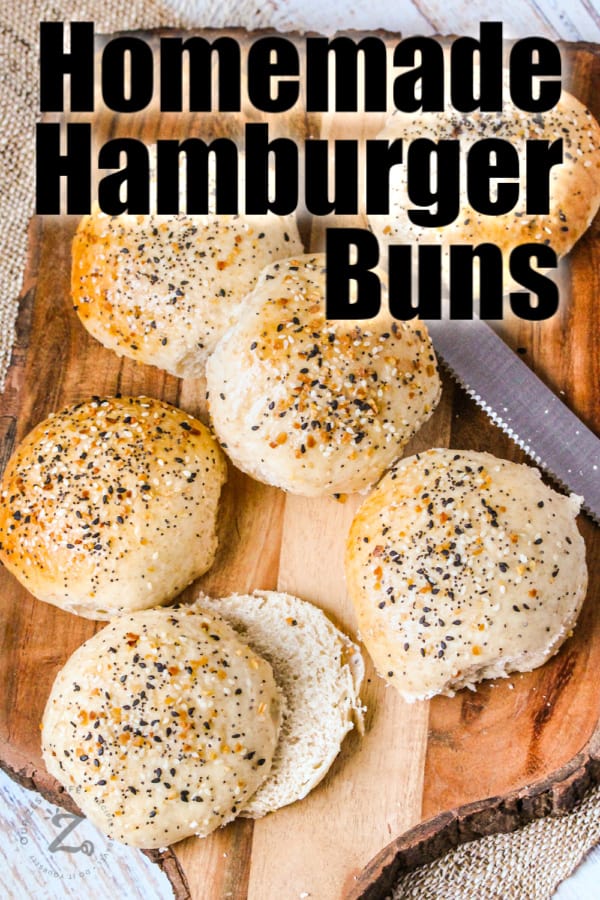 Hamburger buns on a wooden board with a bread knife with a title