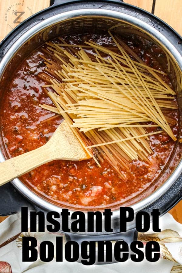 Instant Pot Bolognese with noodles and a spoon with a title