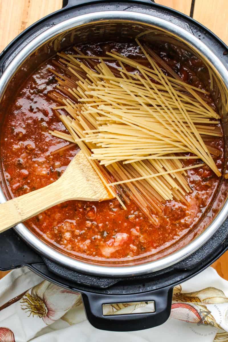 Instant Pot Bolognese with noodles and a wooden spoon