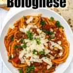 Instant Pot Bolognese in a white bowl with bread and a title