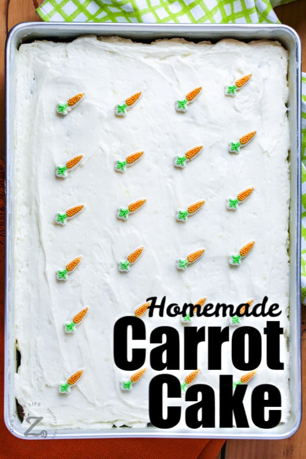 Carrot Cake in a pan decorated with icing and candy carrots and a title