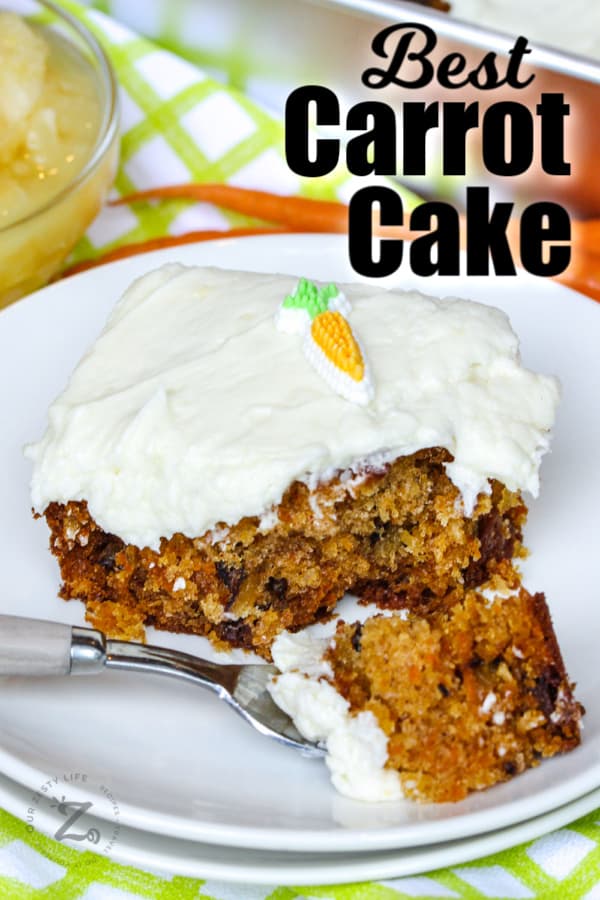 slice of carrot cake on a white plate with a bite of it on a fork with a title
