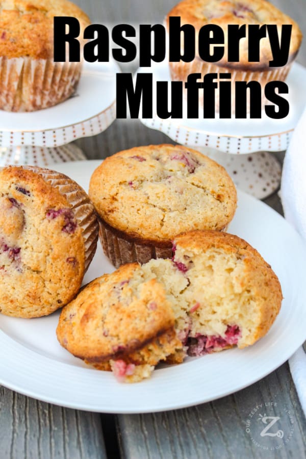 5 Raspberry Muffins on serving plates with one muffin cut in half with a title
