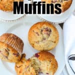 Raspberry Muffins on serving plates with one muffin cut in half, with writing