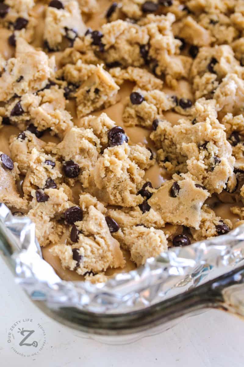 Raw Peanut Butter Chocolate Chip Bars in a dish with tin foil