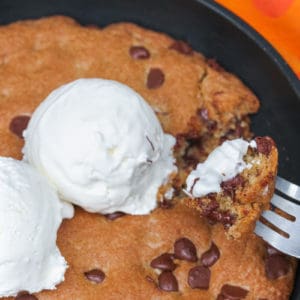 Pizookie in a pan with a fork scooping some out