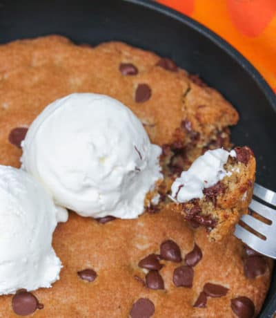 Pizookie in a pan with a fork scooping some out