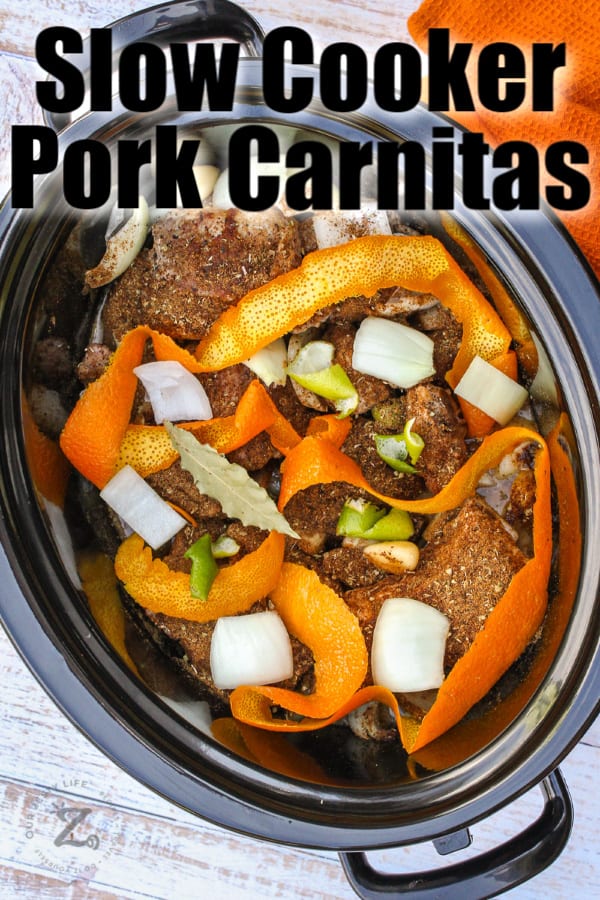 Pork Carnitas ingredients in a crock pot with writing