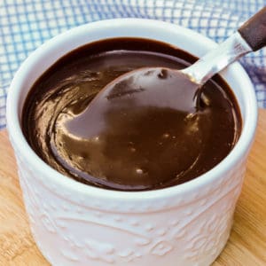 Spicy Chocolate Sauce in a white jar with a spoon
