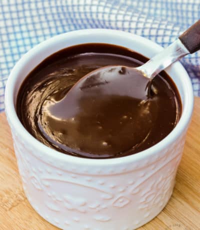 Spicy Chocolate Sauce in a white jar with a spoon