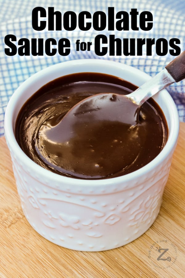 Spicy Chocolate Sauce in a white jar with a spoon and writing