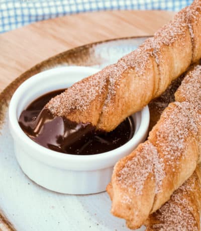 Baked Churros on a plate with chocolate sauce