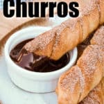 Baked Churros on a plate with chocolate sauce and writing