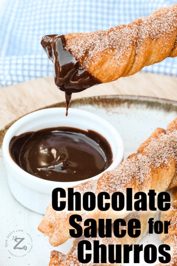 Baked Churros being dipped with chocolate sauce with a title
