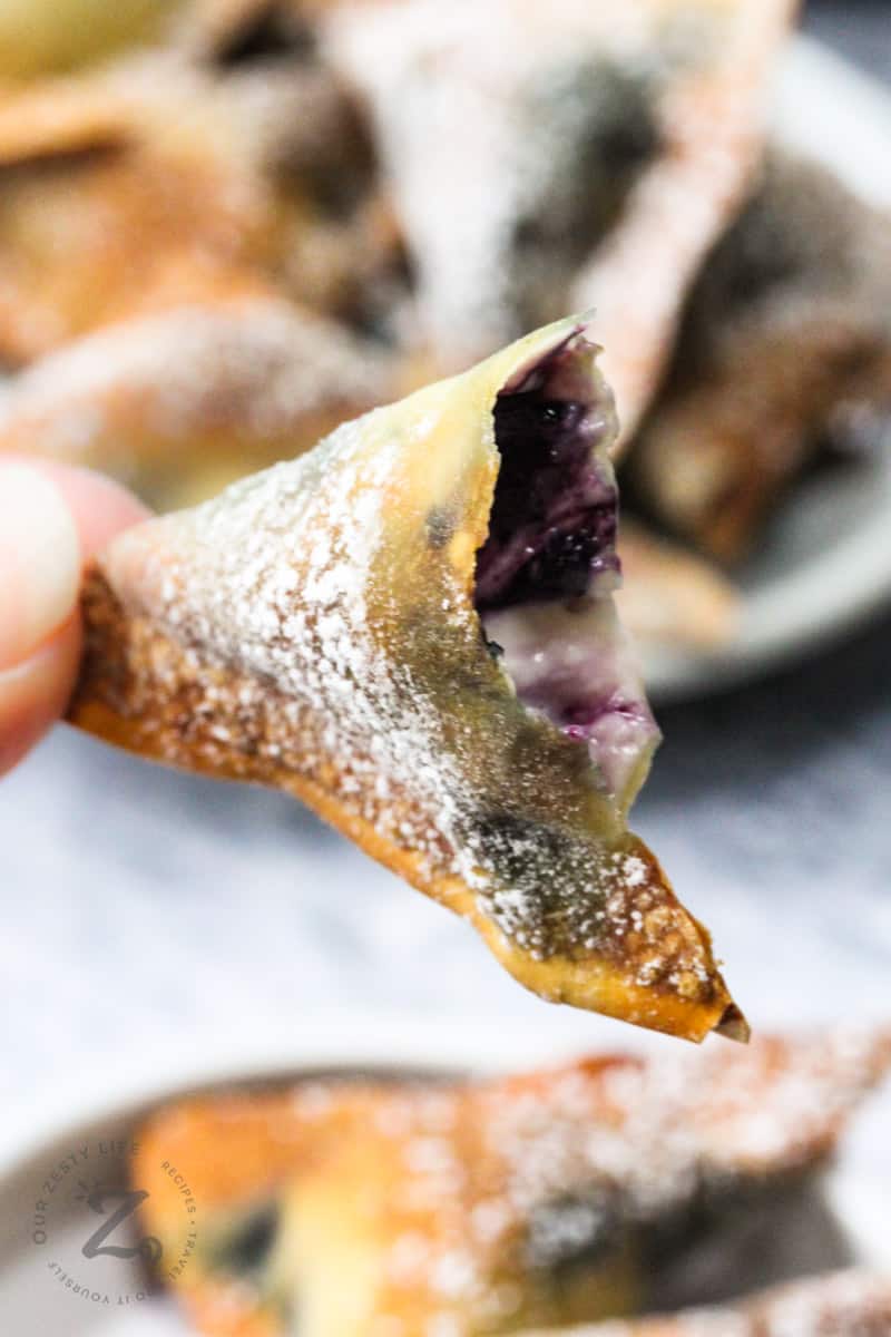 Air Fryer Blueberry Wontons in half to show filling