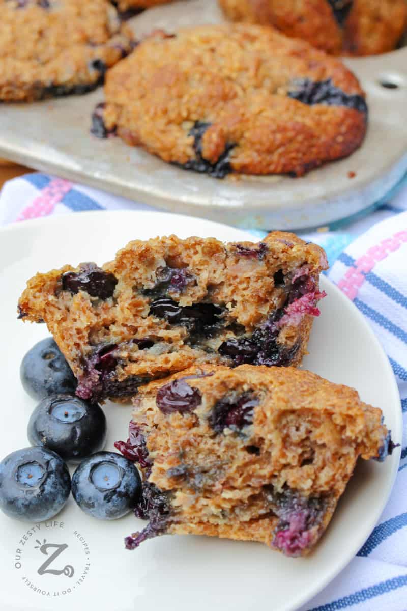 open Blueberry bran muffins on a plate