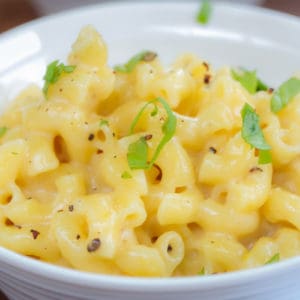 Homemade Creamy Mac and Cheese close up in a white bowl