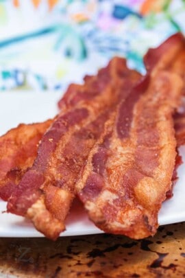 close up of Bacon in the Oven on a white plate with a napkin