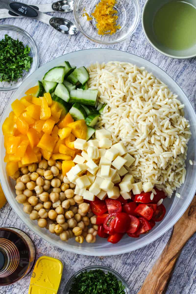 top view of Orzo Pasta Salad in a bowl with ingredients
