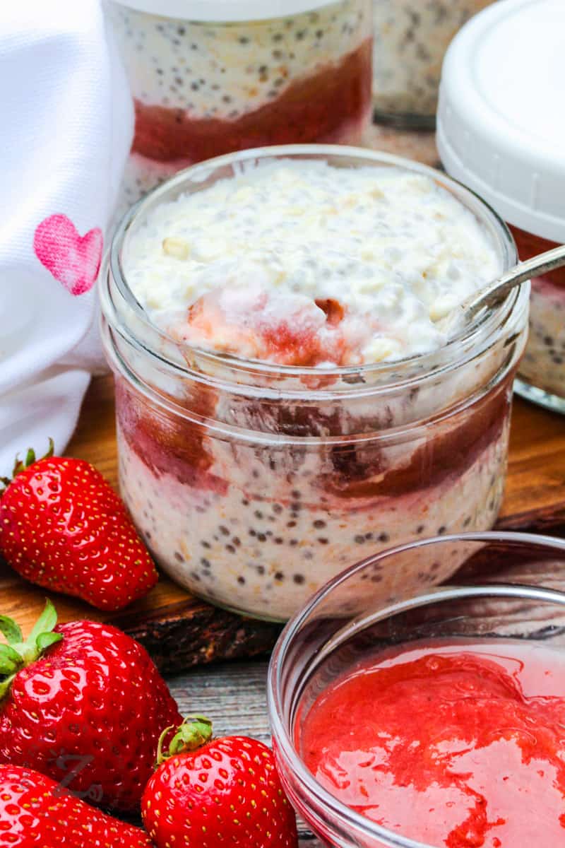close up of Overnight Oats with Strawberry Rhubarb Compote with a spoon in it