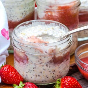 Overnight Oats with Strawberry Rhubarb Compote with a spoon in it