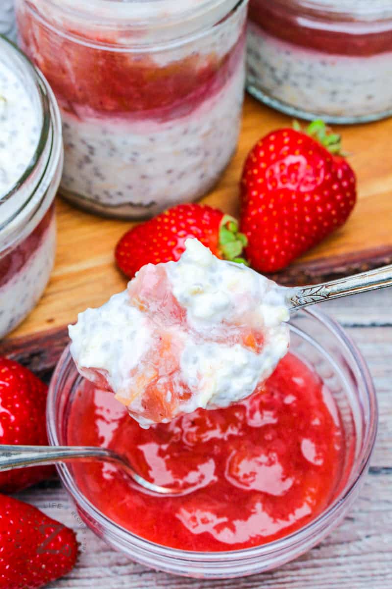 bite of Overnight Oats with Strawberry Rhubarb Compote on a spoon